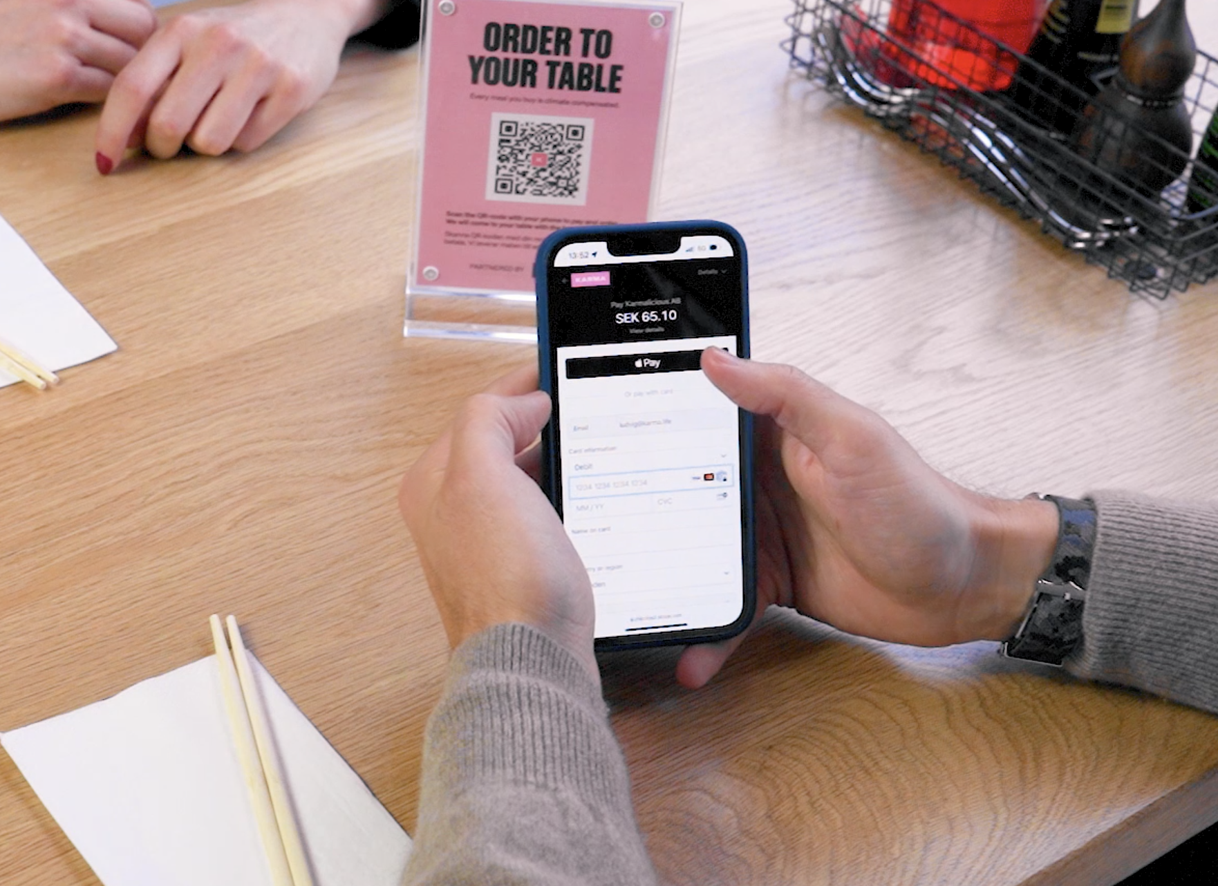 A customer paying using Karma