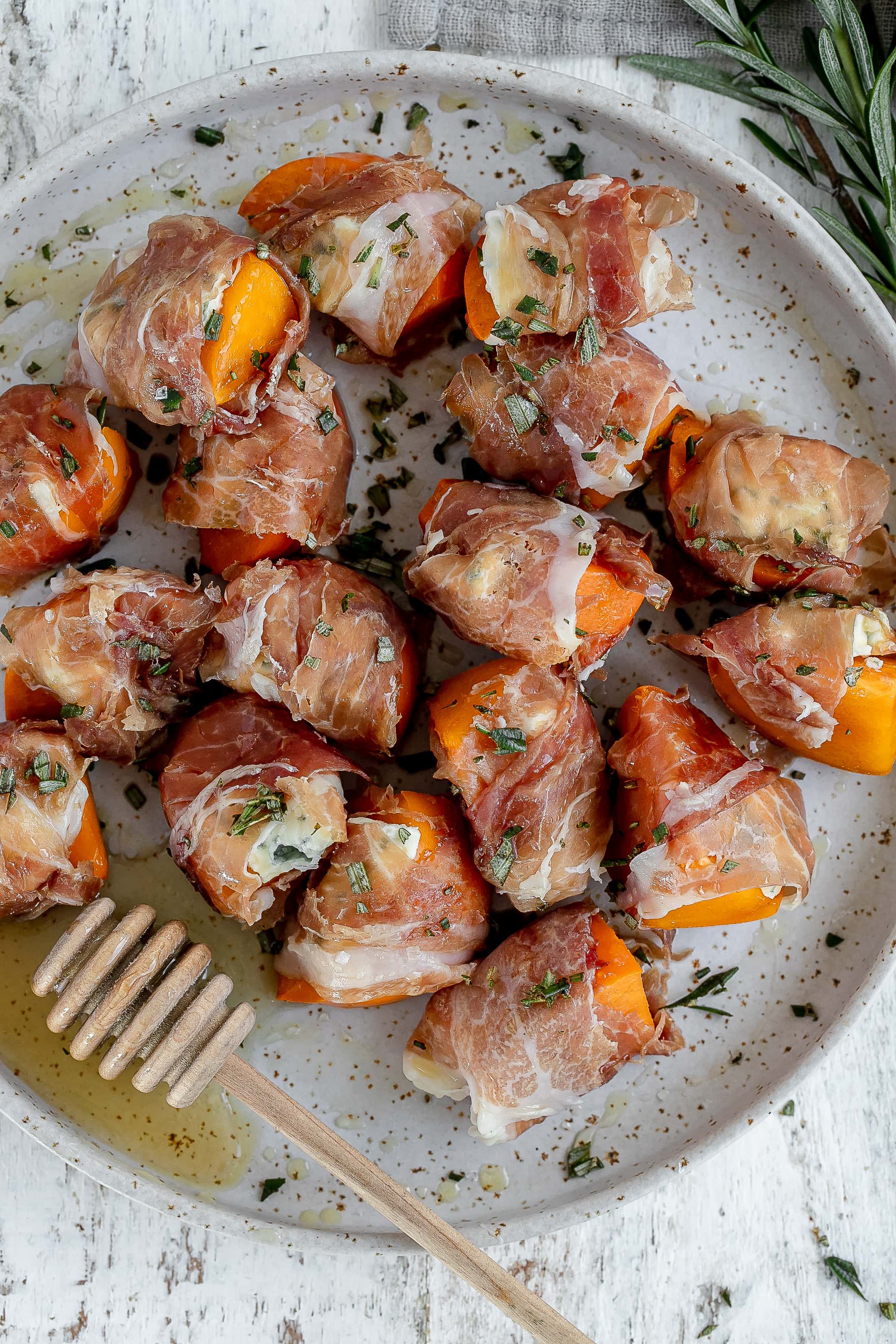 persimmon wrapped prosciutto on plate 