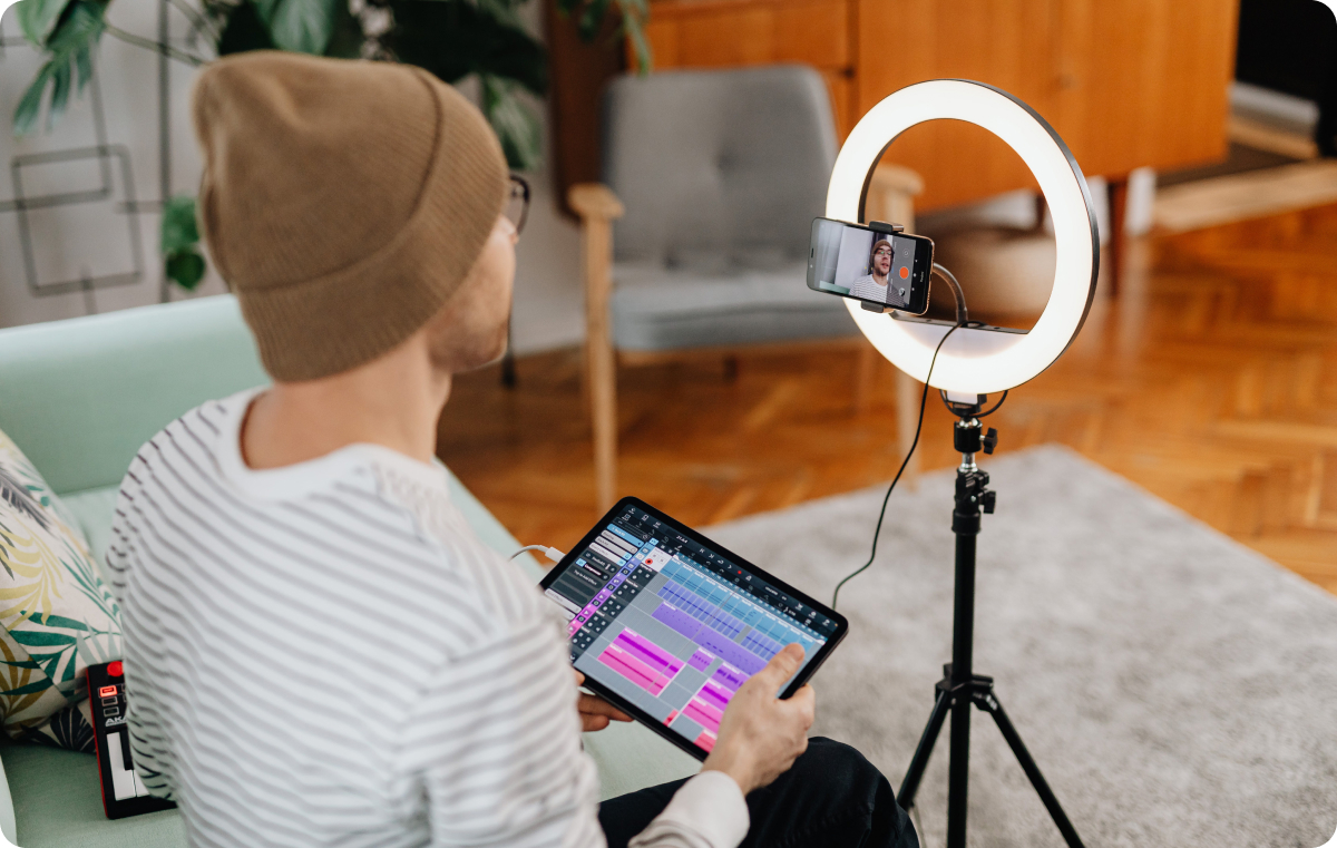 Creator filming video on phone with a ring light