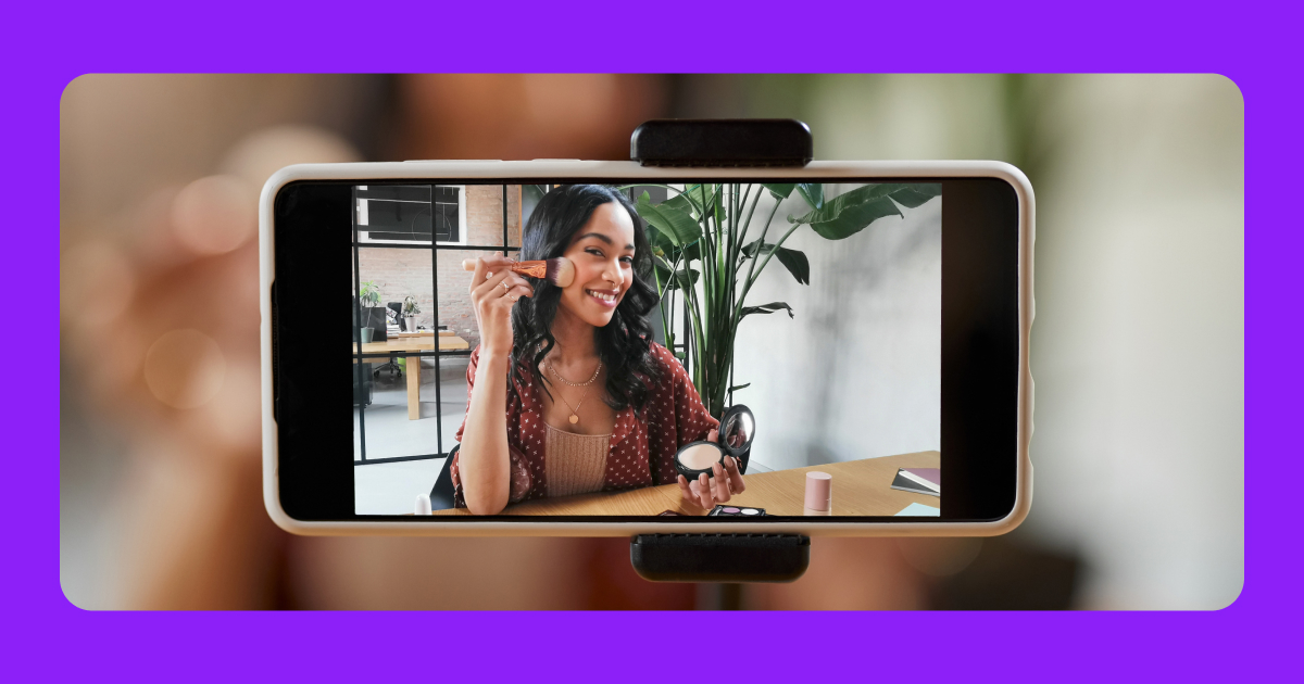 A person holding an iPhone and filming another person in front