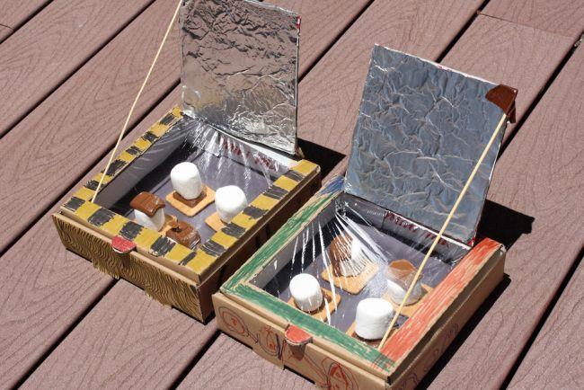 Solar ovens built from pizza boxes, with marshmallows, chocolate, and graham crackers - an outdoor stem activity for kids