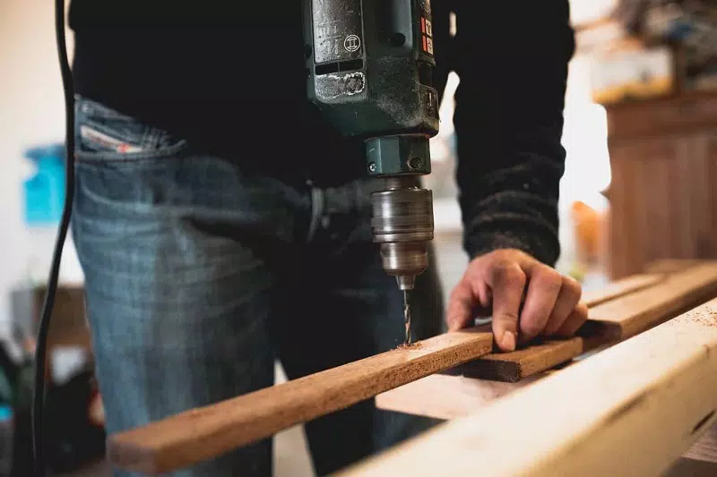 A man drilling on stick 