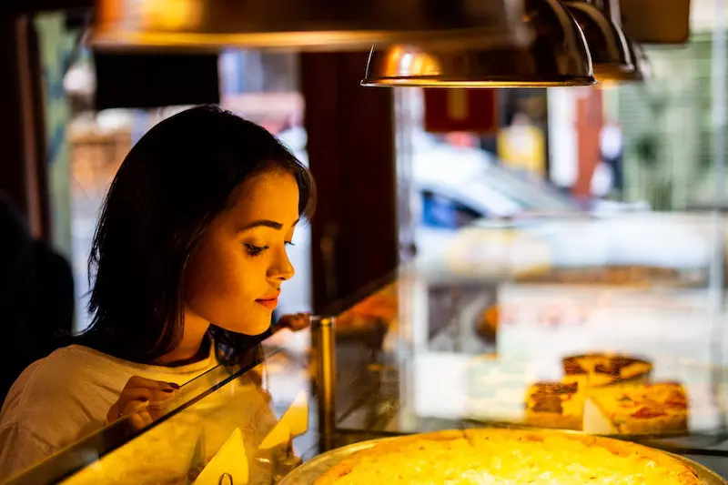 A lady looking at food in store