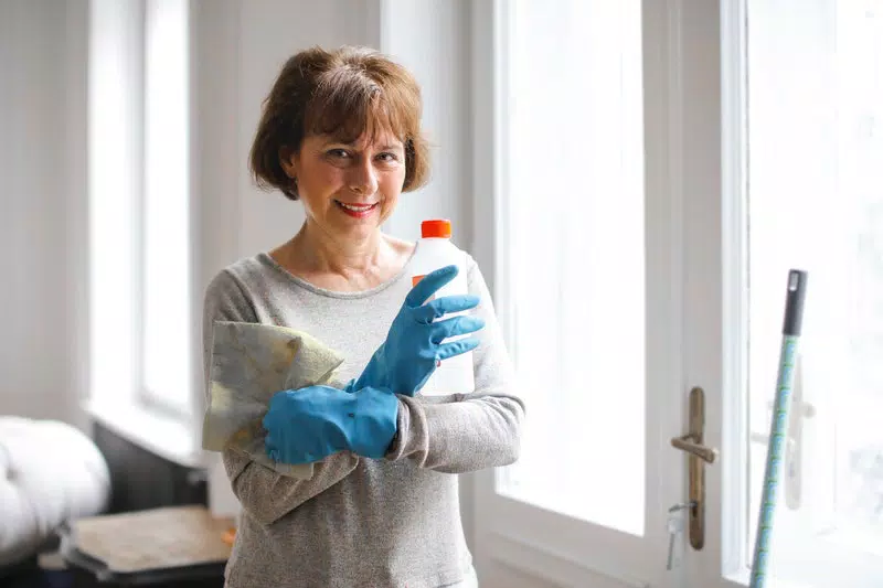 A lady with cleaning material