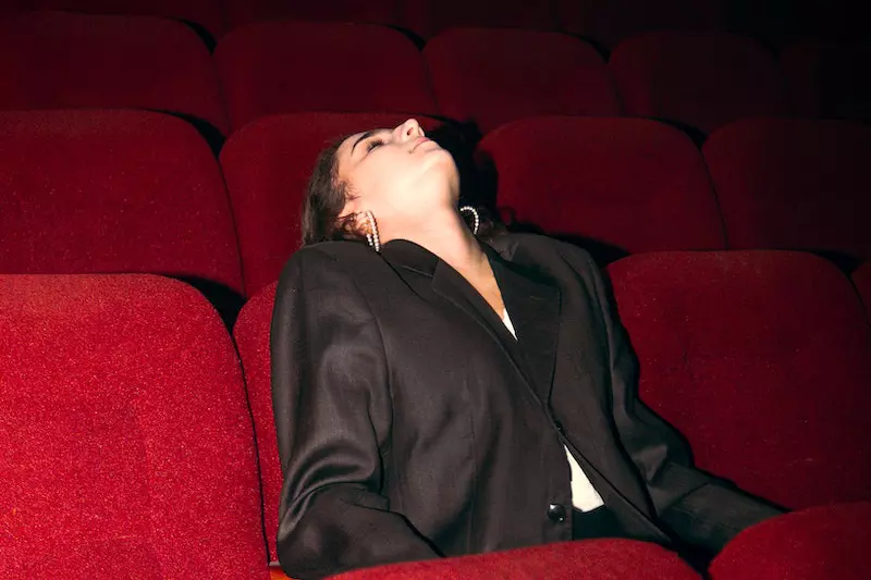 A lady fall a sleep on cinema hall