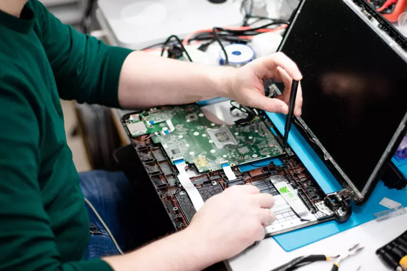 A man repairing  laptop 