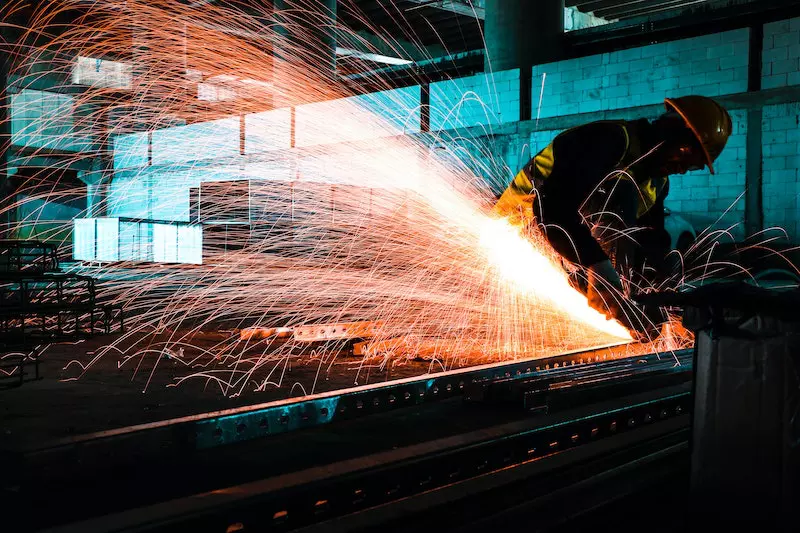 A man cutting steel