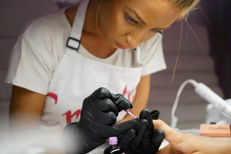 A lady painting nail polish 