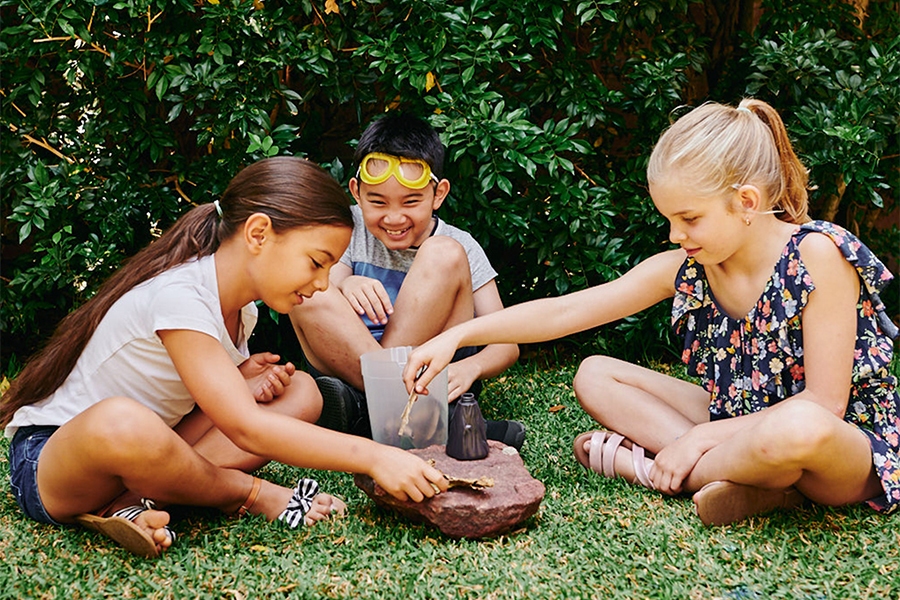Young children playing with volcano STEM learning activity