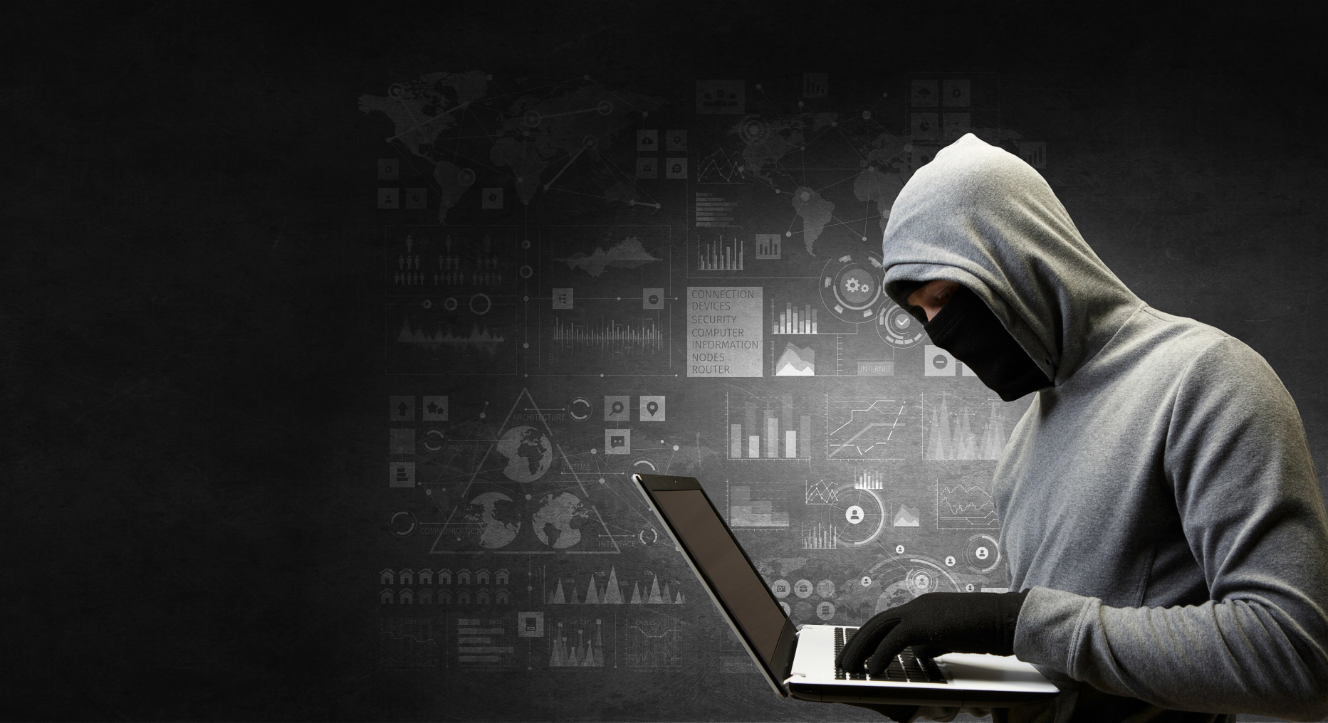 A hacker sitting in front of a computer.