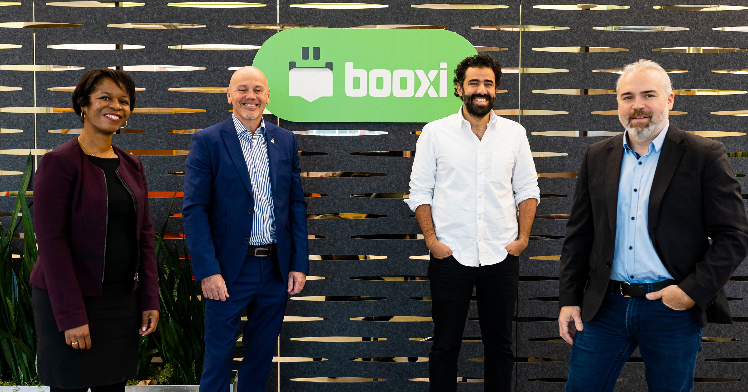 Group portrait including Booxi's cofounder Elie Perez and Daniel Laplante, next to Sandrine Wasukama and Bernard Rousseau from Investissement Québec.