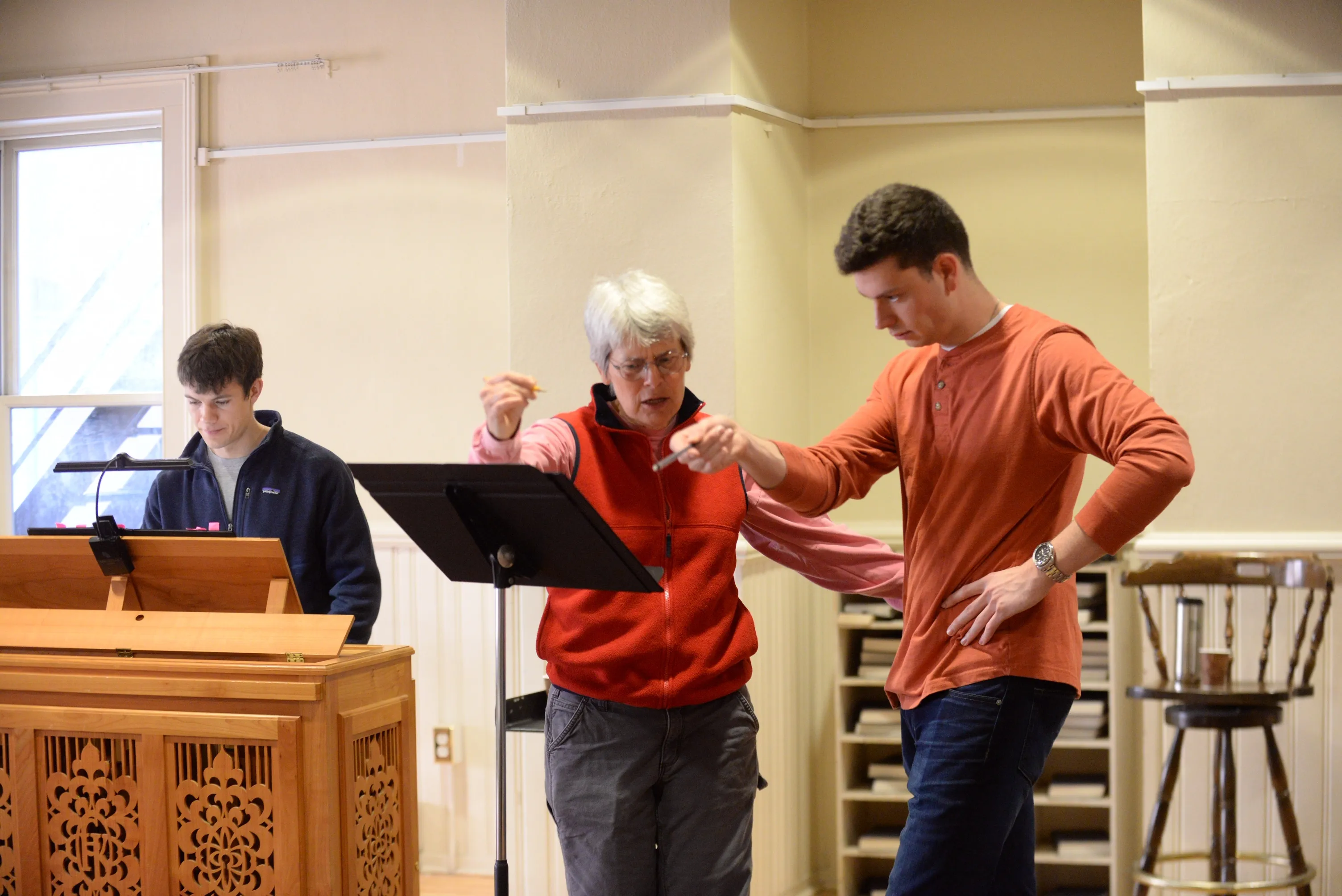 A music teacher coaching a music student