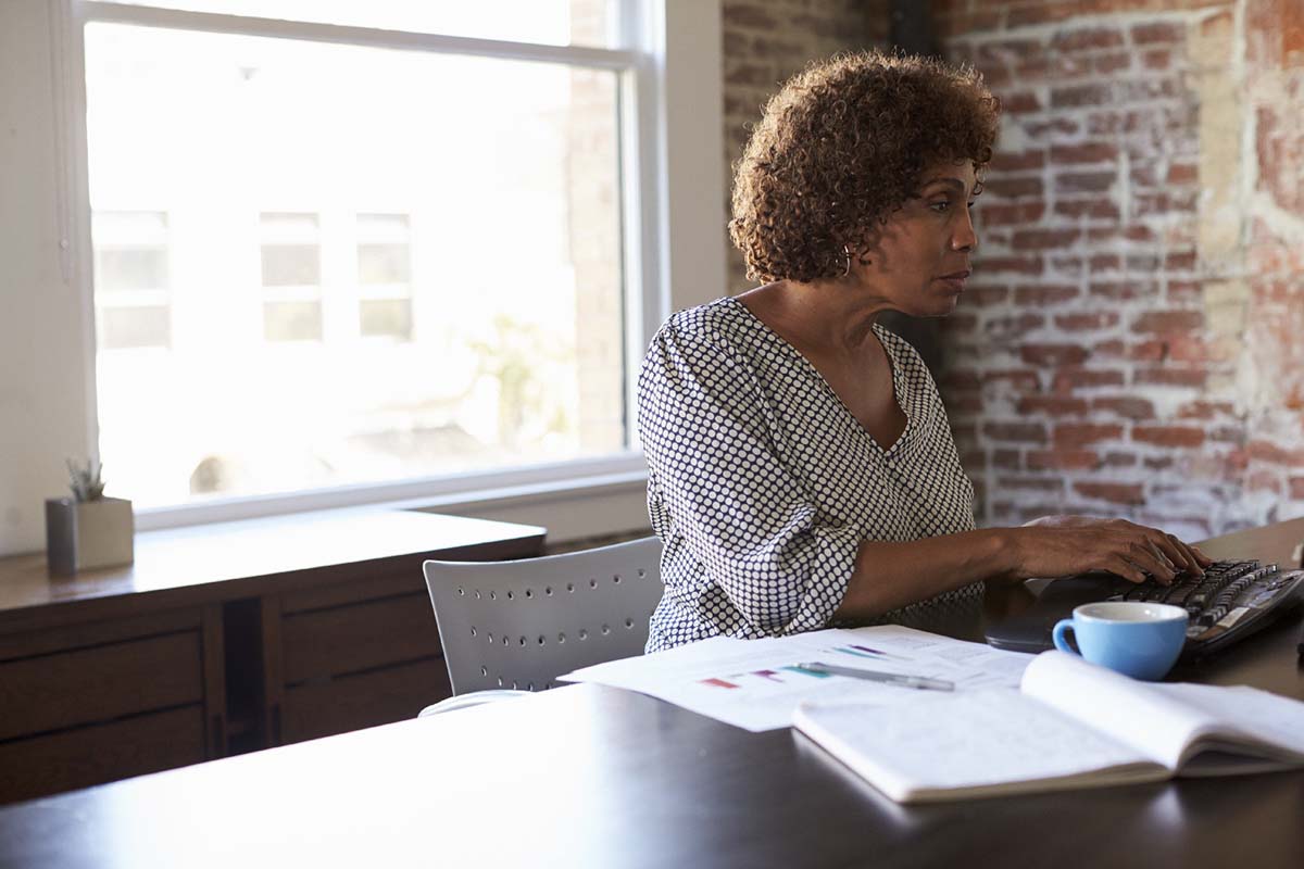 A woman typing at a desk