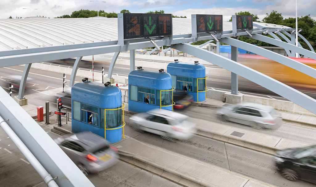 cars traveling through toll booth at bridge