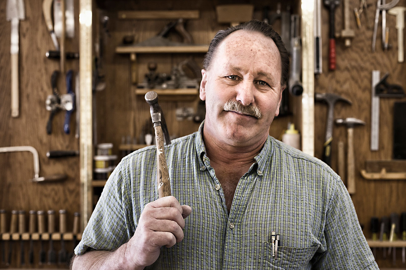 Portrait of confident carpenter with work tools at workshop|Boost Self Employed Income With These 8 Tips