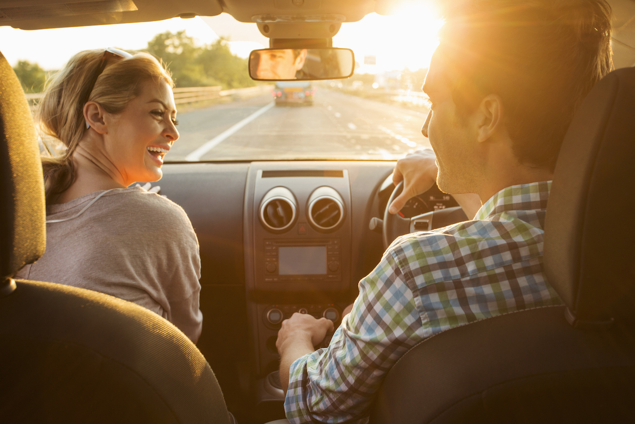 Man and woman driving and chatting: Passenger Payments on Taxes