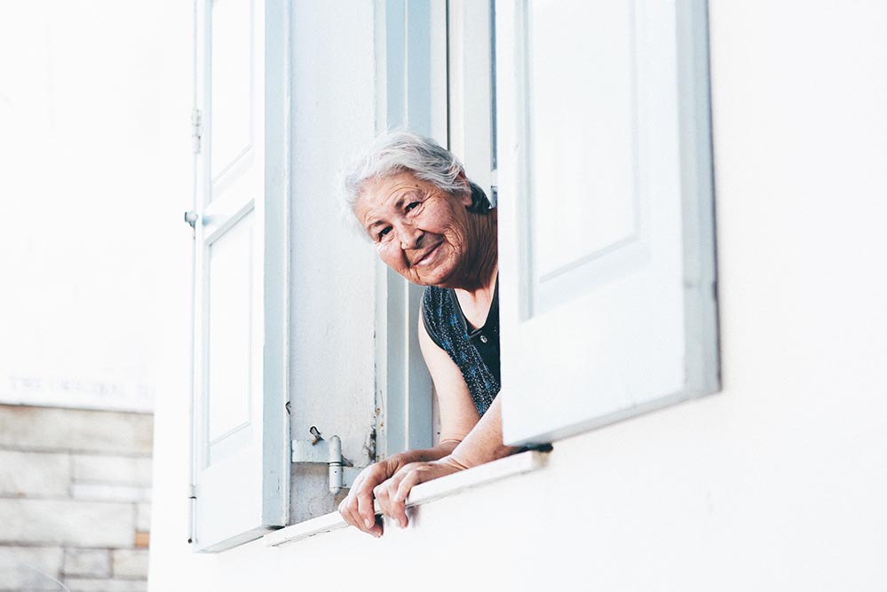 A woman looks out a window