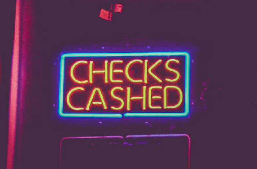 A neon sign that reads Checks Cashed