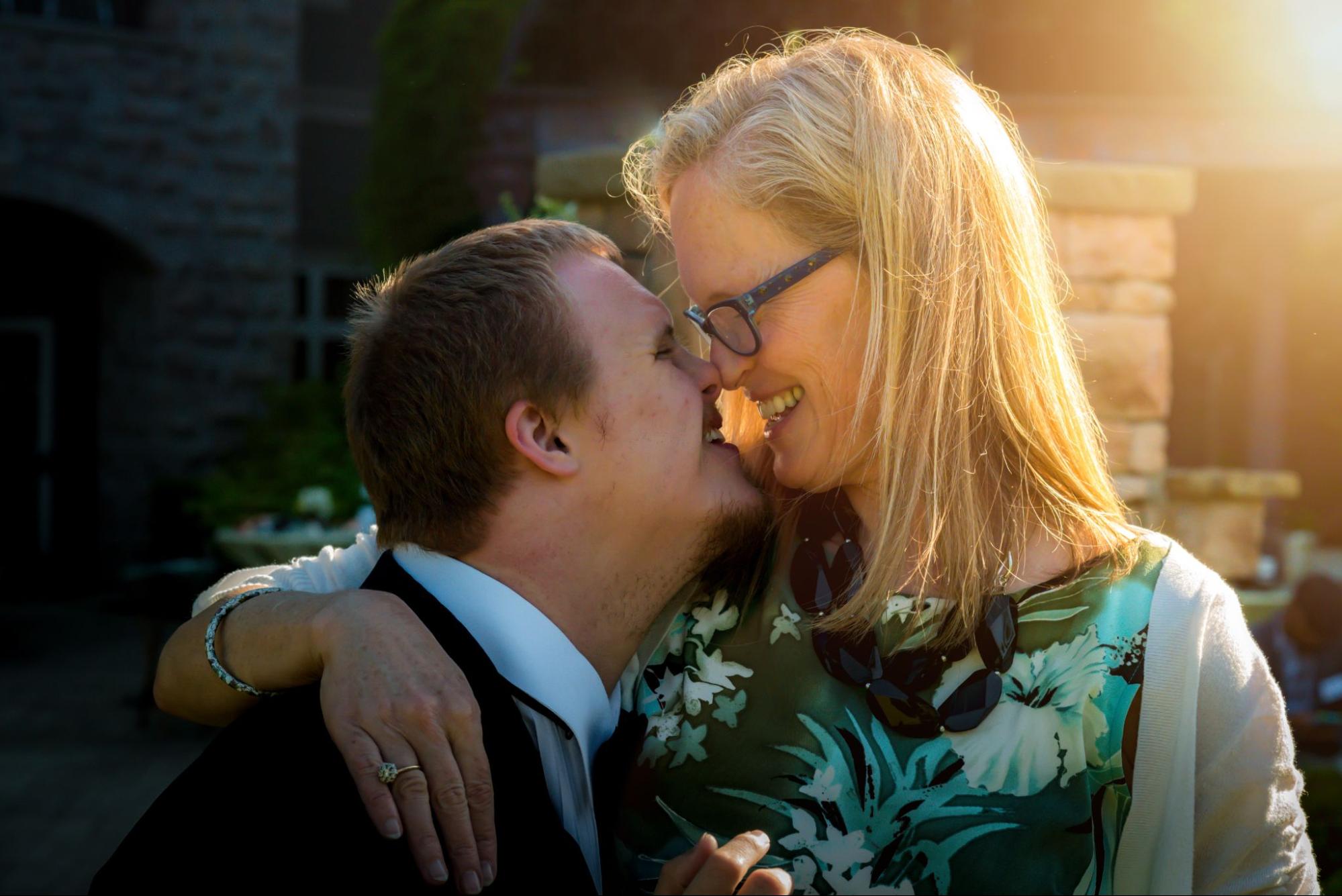 A man and woman smile with their noses touching