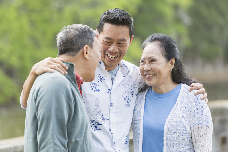 image of a son embracing his mother and father