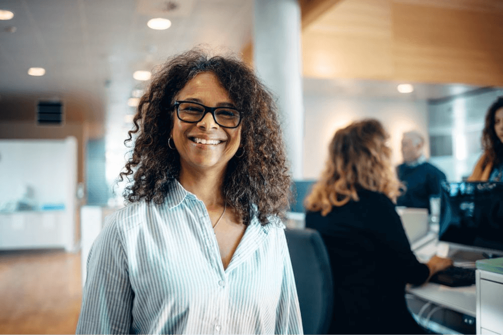 woman sitting in an office and smiling