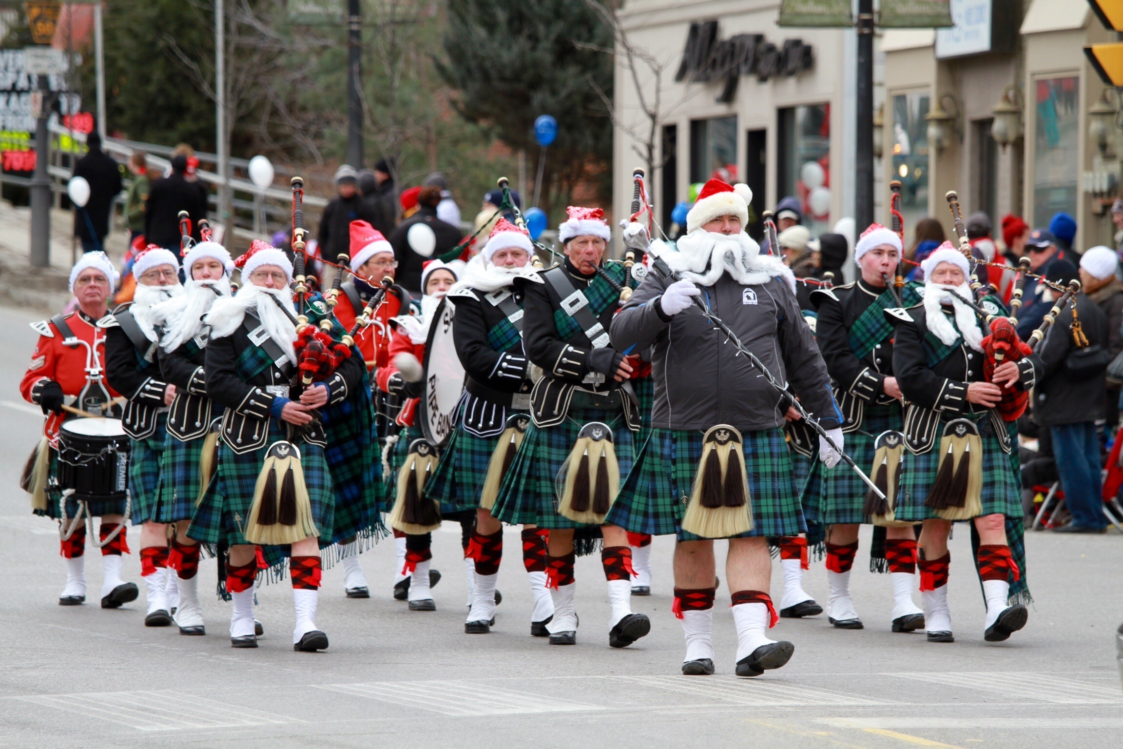 A band dressed as Santa Claus marches in a parade