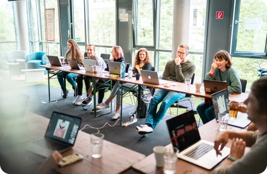 A group of people are siting in the front of their lap-tops - Simple Club