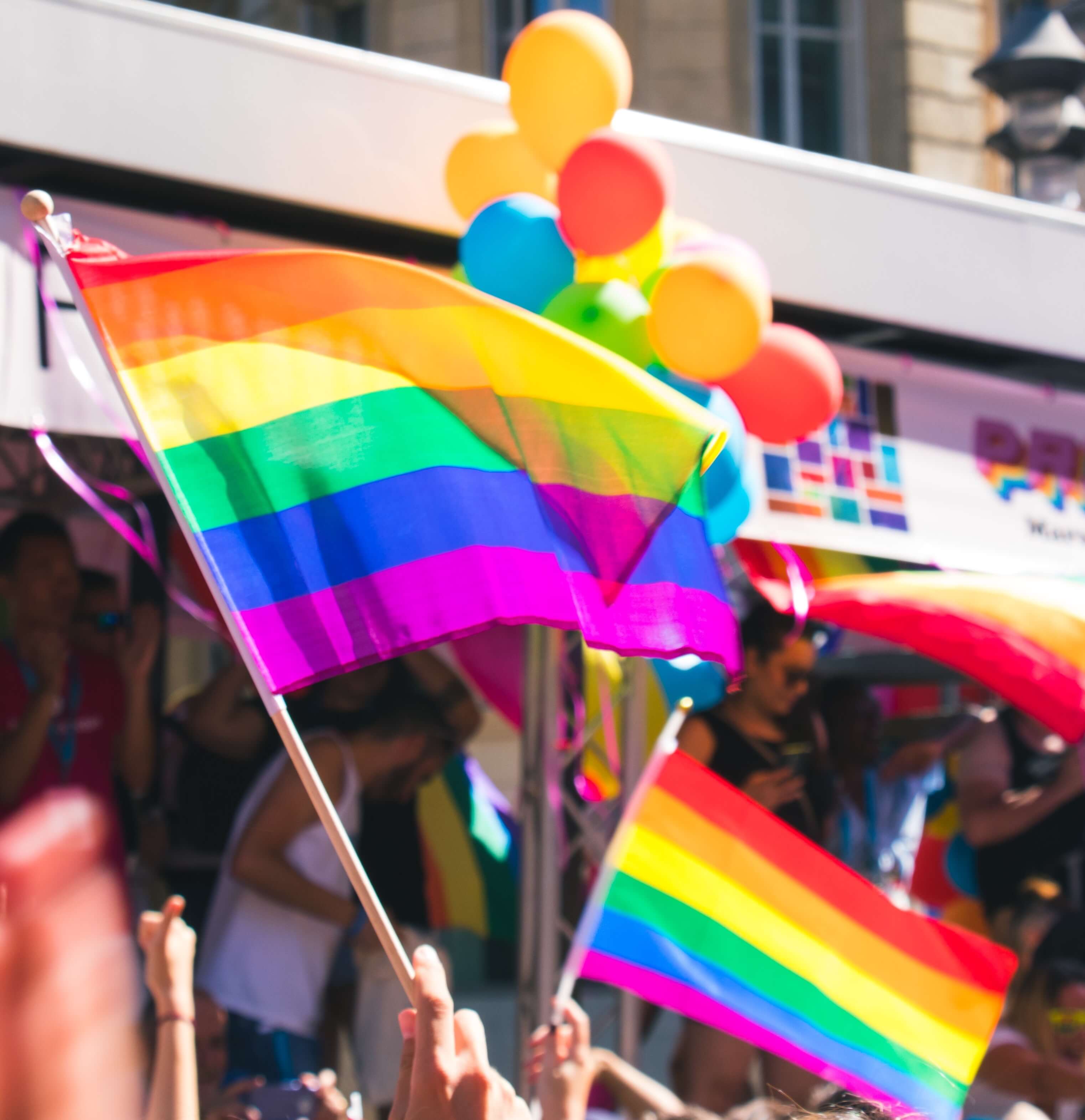 People holding rainbow flags