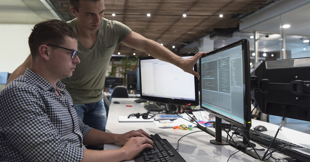 Two developers working on a computer
