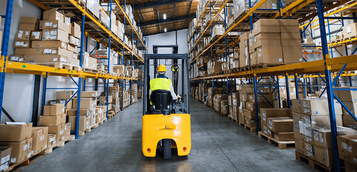 Worker driving a forklift in a warehouse