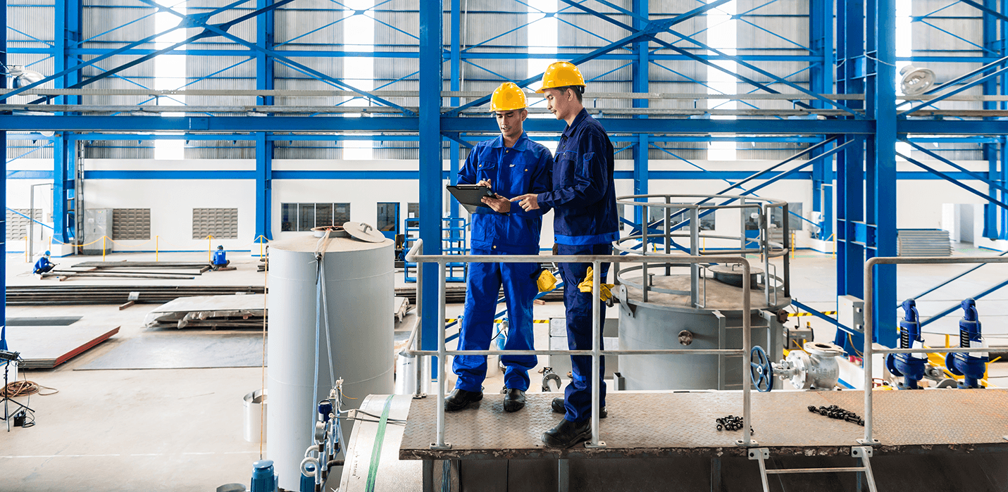 Workers in large metal workshop