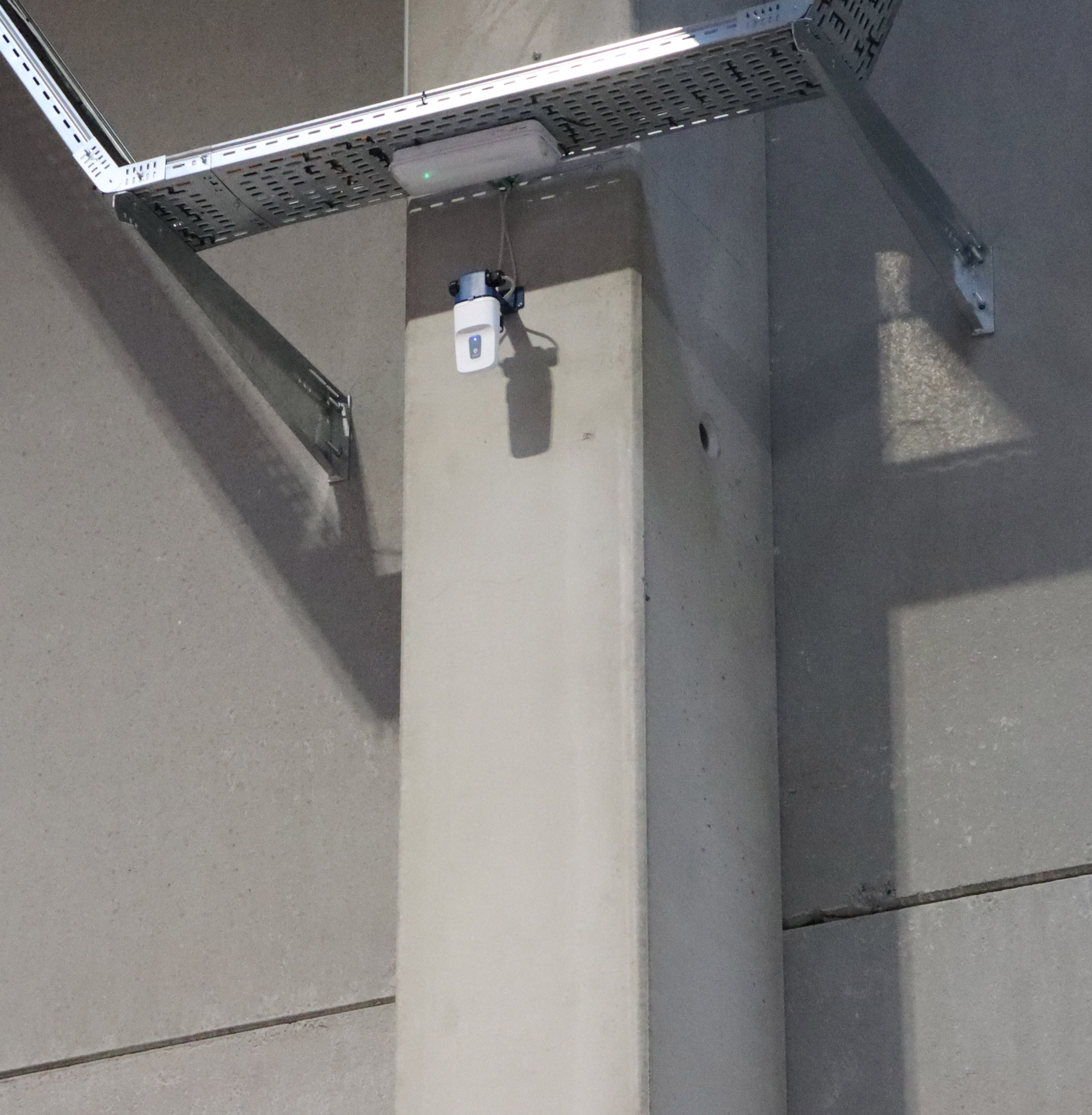 A Pozyx Enterprise anchor on the ceiling of a warehouse