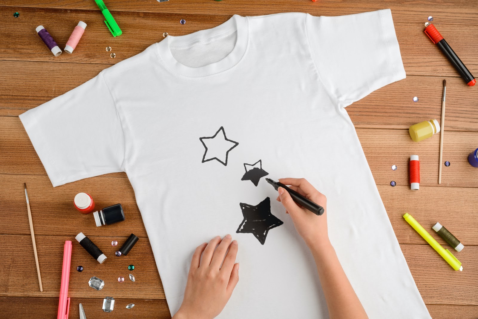 Person doodling on t-shirt