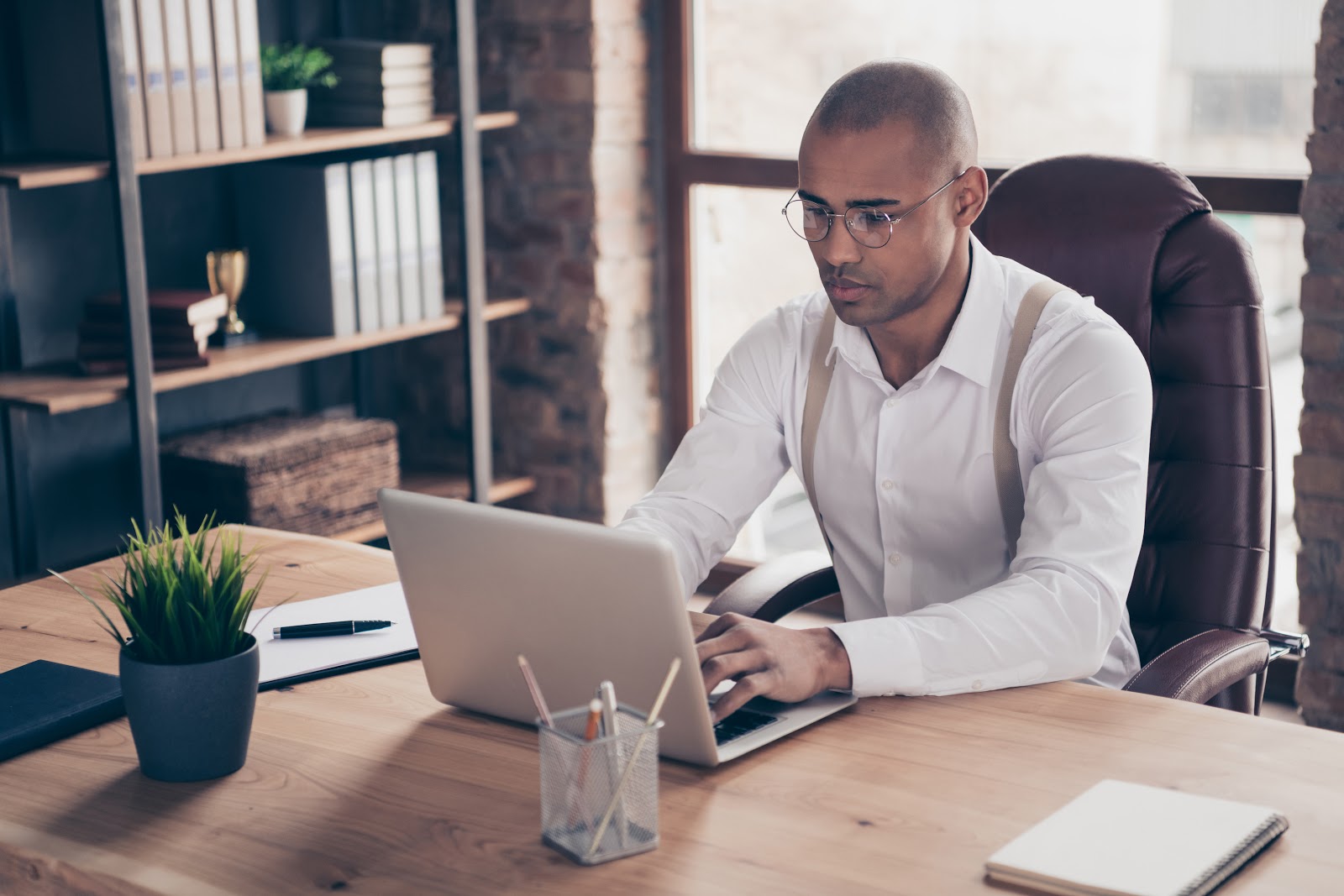 Man typing on his laptop