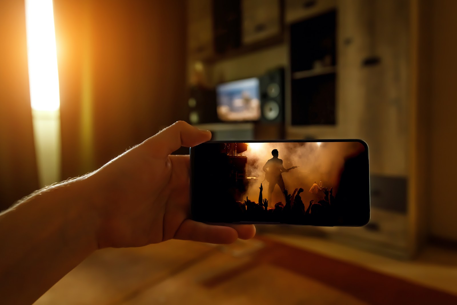 Virtual fundraising events: Person watching online concert on their phone