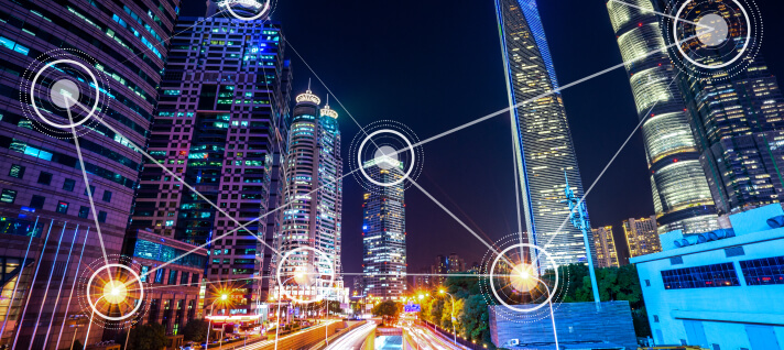 Smart city with fast moving traffic and data points on buildings