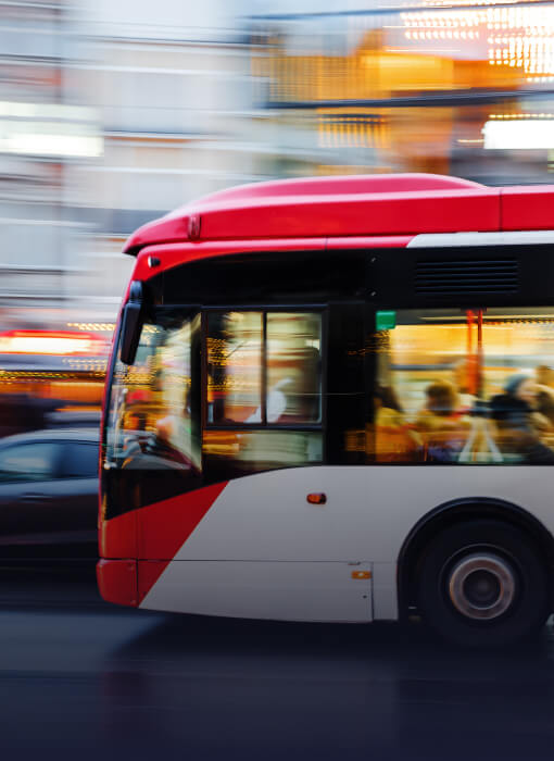 Public bus zooming down the road in a city
