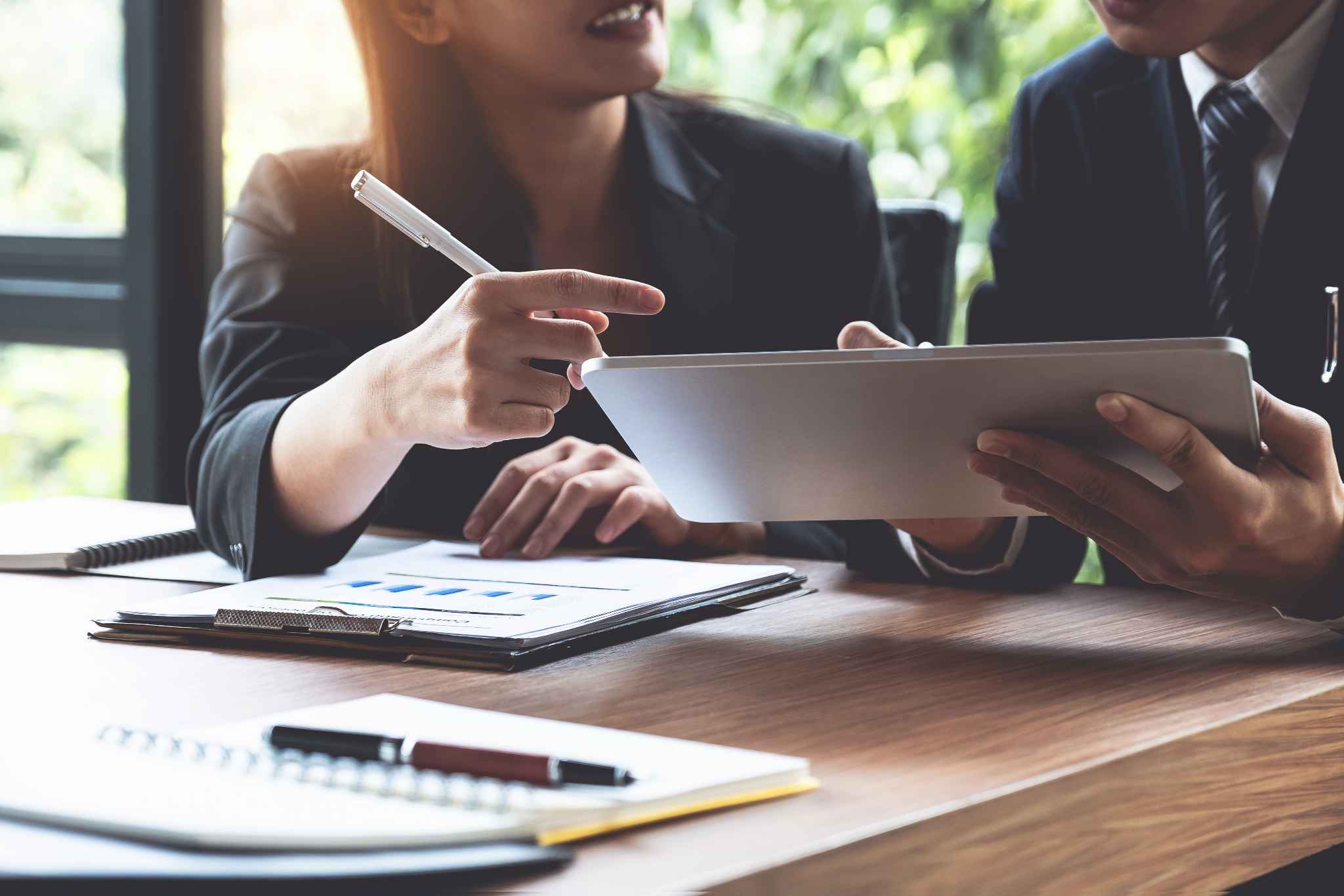 Two people review a contract at a table