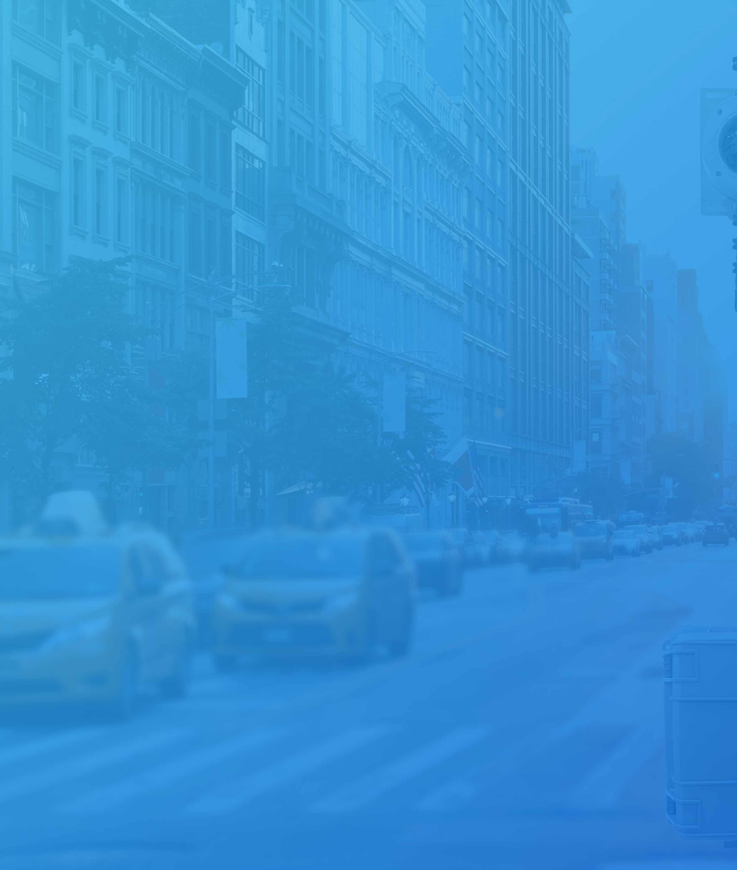 New York City street with taxis and other cars driving with a blue gradient overtop