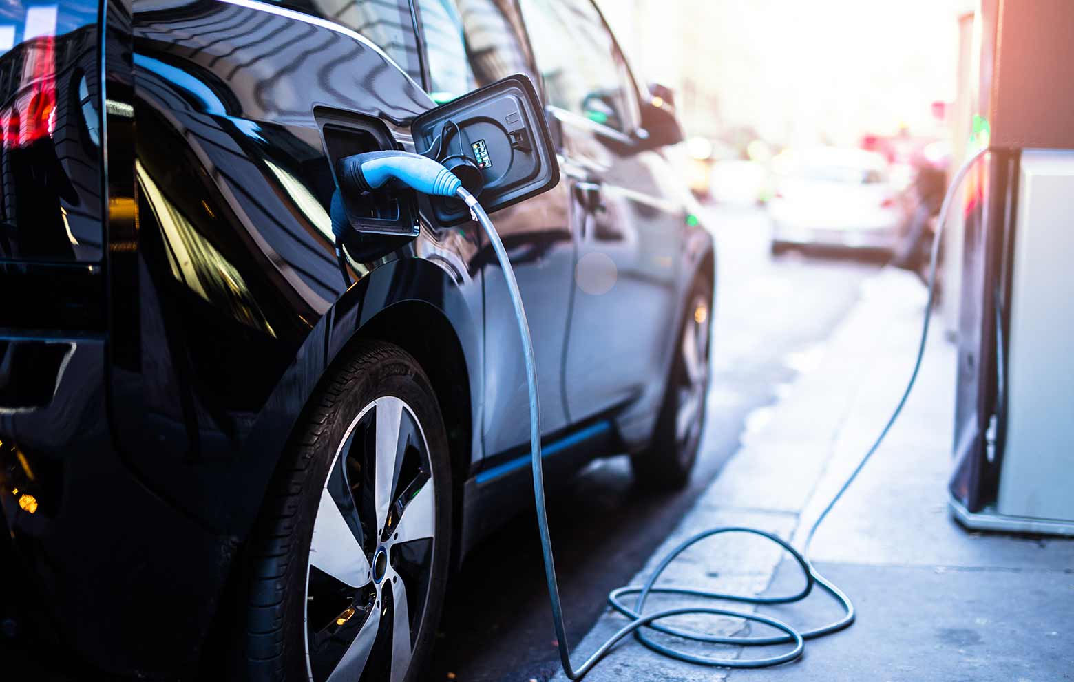 Charging modern electric car on the street which are the future of the Automobile