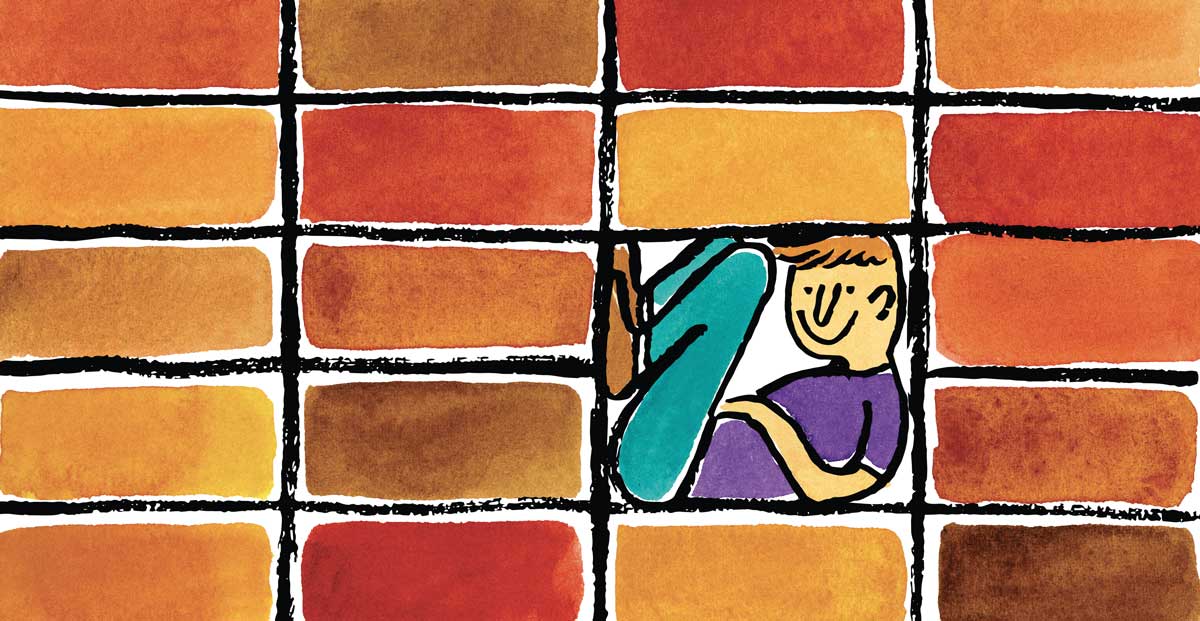 a person sitting in a brick wall