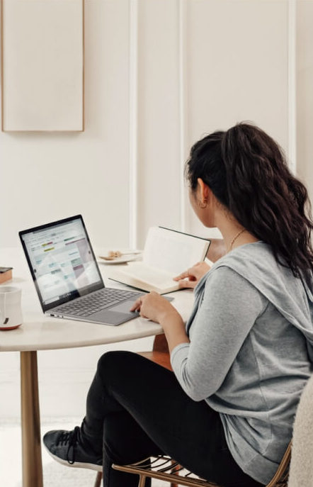 Image of a girl sitting looking at her computer