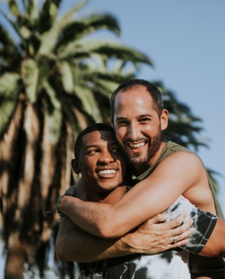 A male giving his male lover a piggyback ride

