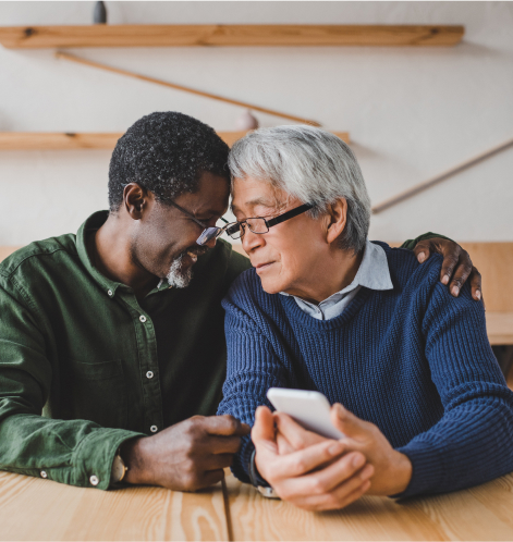 A man putting his arm around his male lover while leaning on each other's head. 
