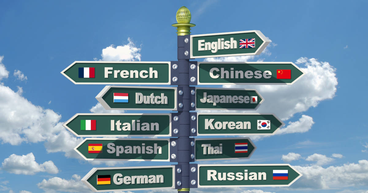 A signpost pointing into different directions with languages written on it (source: Shutterstock).