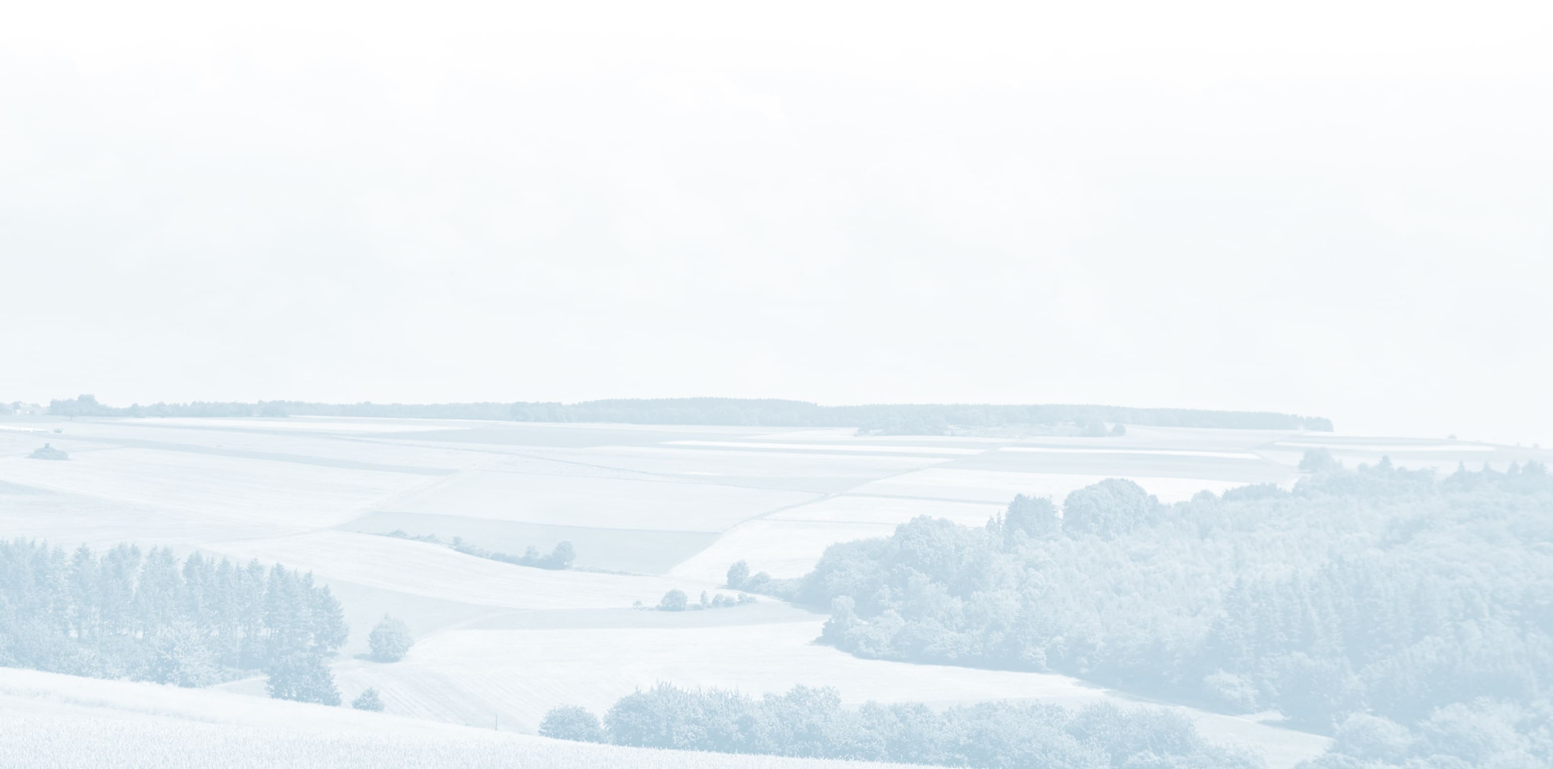 A faded farmland photo used as decorative background
