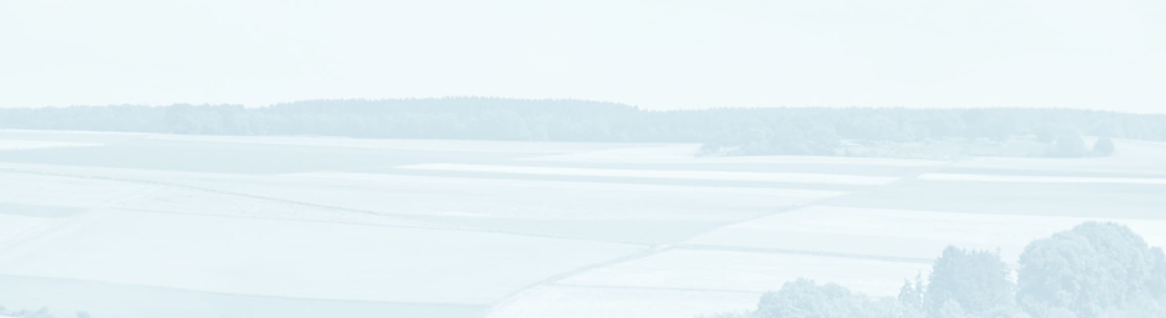 A faded farmland photo used as decorative background