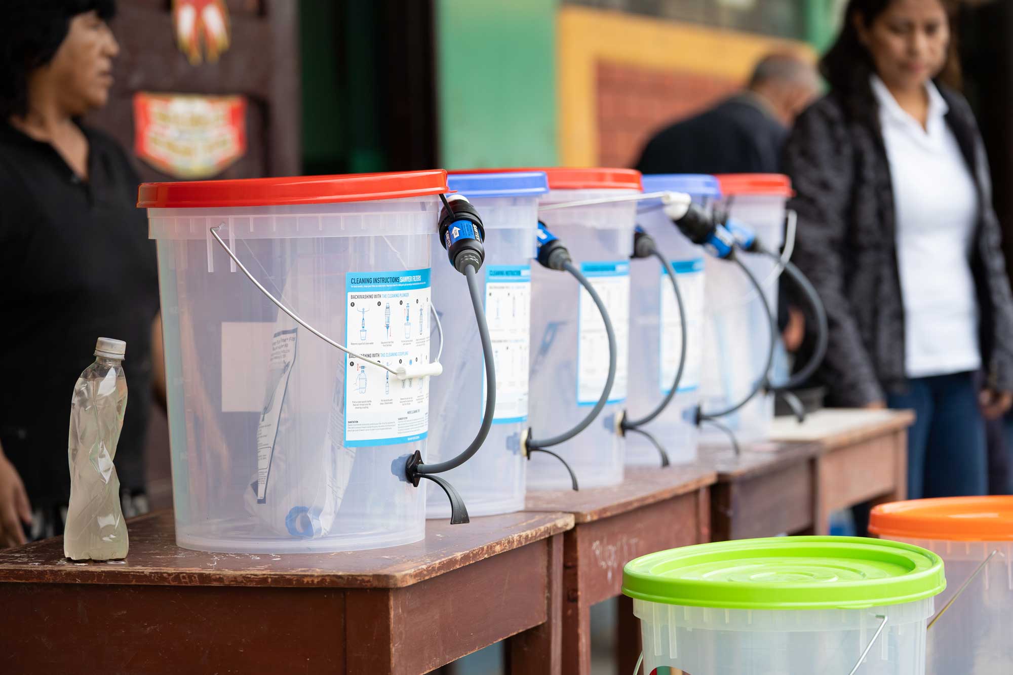 A Display of Sawyer Bucket Water Filter Systems during a Presentation