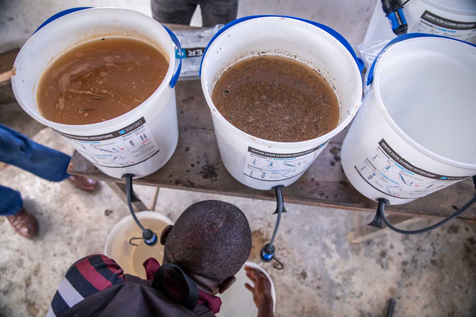 Sawyer Bucket Water Filtration Systems Showing Dirty Unfiltered Water