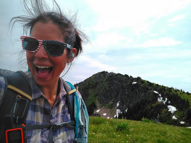 Happy hiker on mountain wearing sunglasses